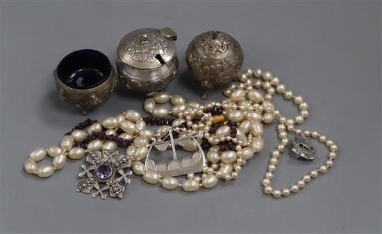 An Indian white metal three piece condiment set, three silver Scottish brooches, a garnet necklace and two pearl style necklaces